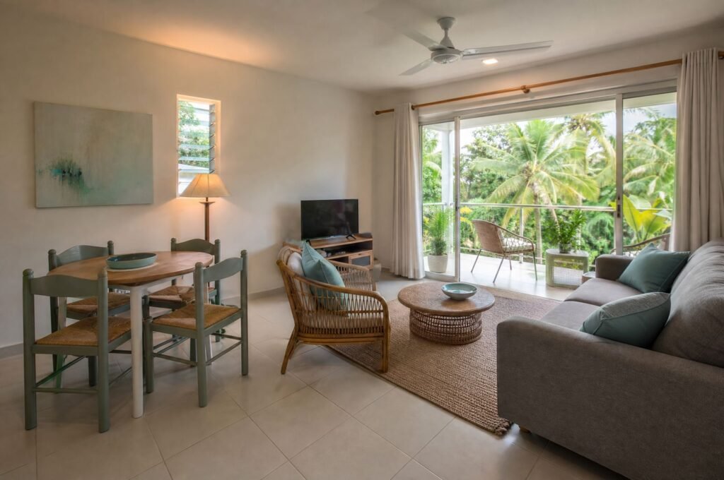 Living room at Hummingbird Apartment with a sofa and balcony doors