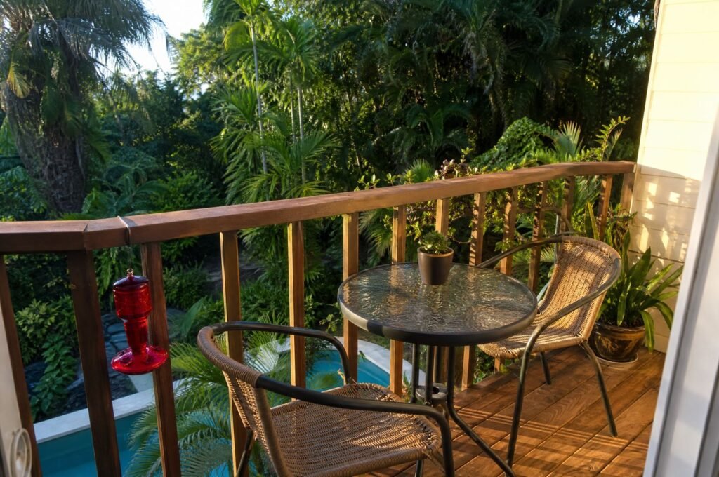 Balcony at Hummingbird Apartment with a table, a hummingbird feeder and the garden below