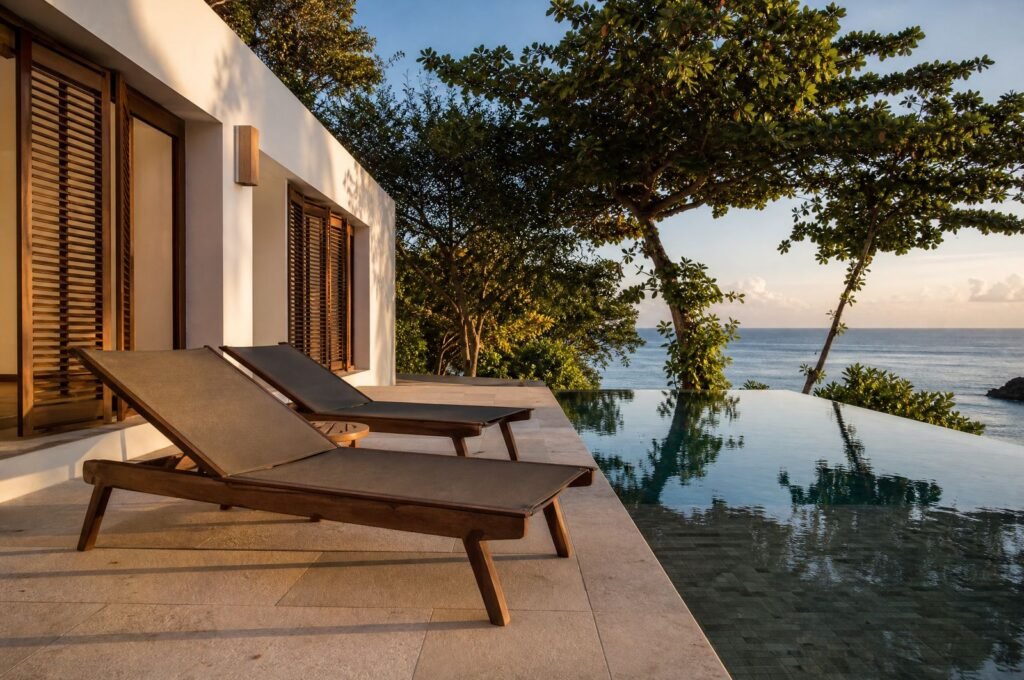 Pool deck with loungers at Seagrape House in late afternoon light
