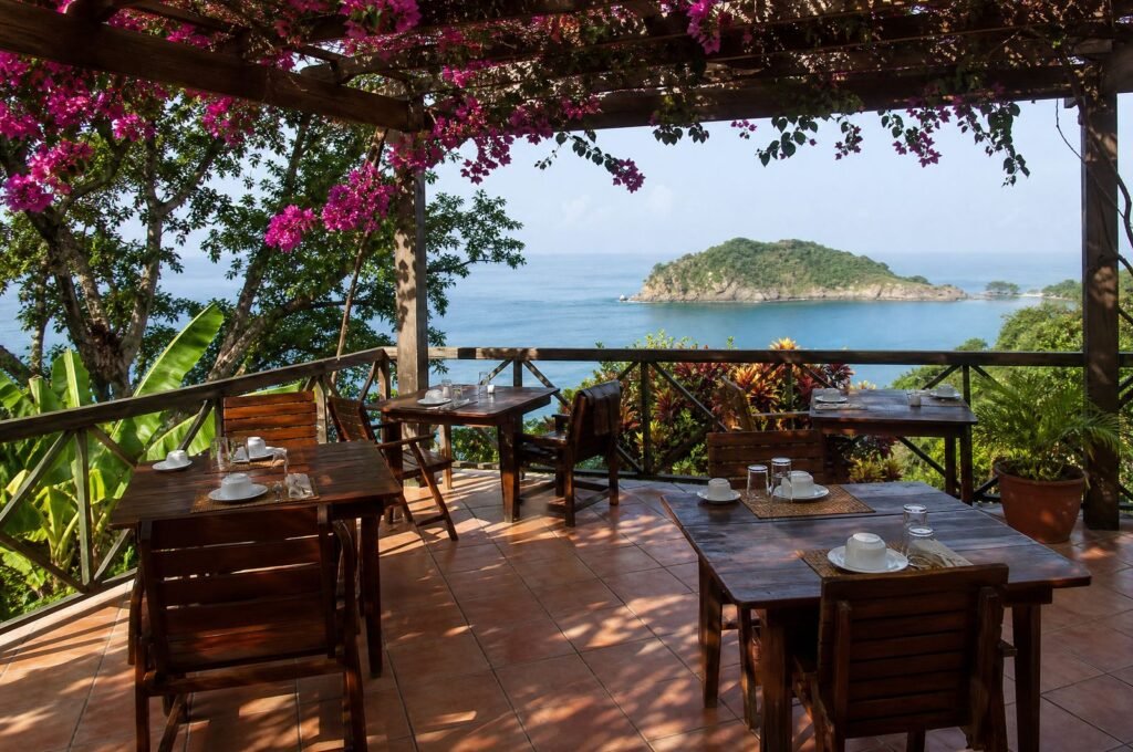 Breakfast terrace at the Speyside guesthouse with tables set and a sea view